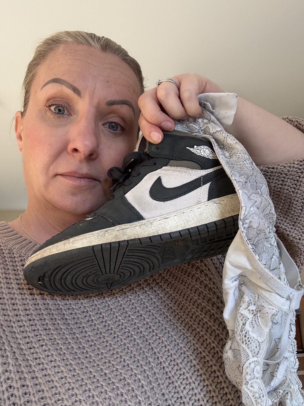 Vicky on a Tuesday afternoon, holding a dirty Jordan and a pair of lace knickers